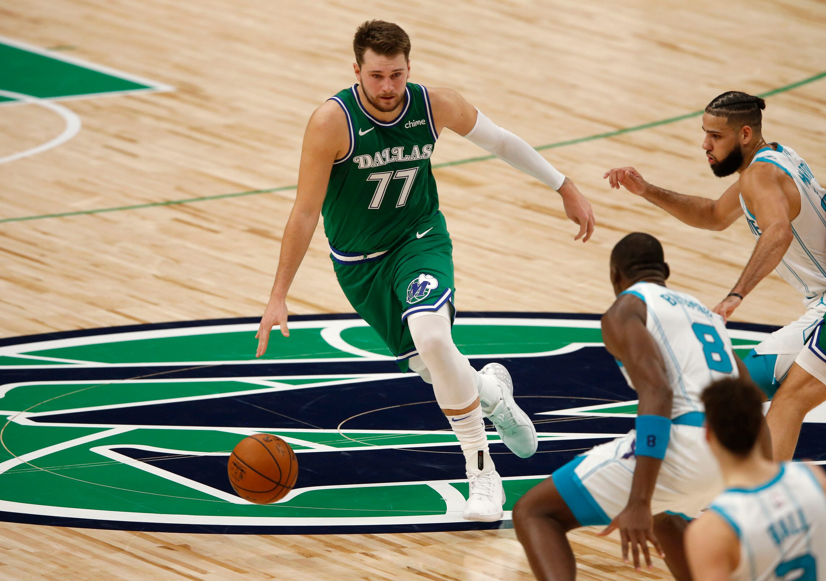 Dallas Mavericks guard Luka Doncic (77) pushes the ball up the court as Charlotte Hornets...