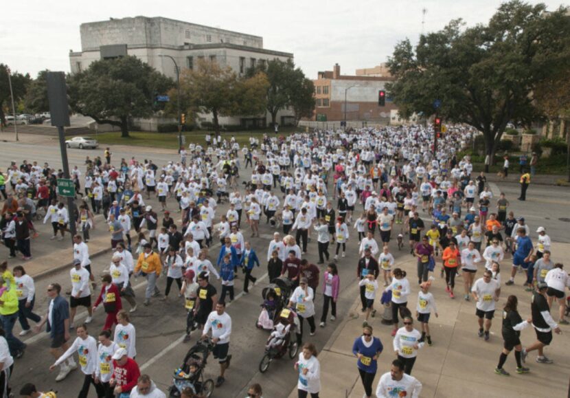 Participants in the YMCA Turkey Trot make their way down Young St. on Thursday, Nov. 22,...