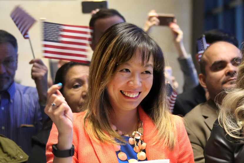 Aura Yanita Ruotolo of Indonesia is all smiles as she's sworn in as a U.S. citizen in Fort...