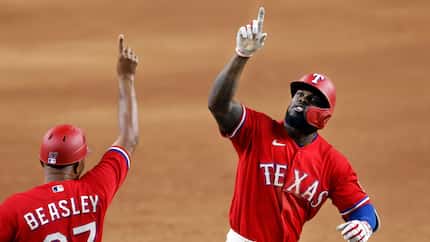 Texas Rangers batter Adolis Garcia (right) celebrates his walk-off 3-run homer in the tenth...