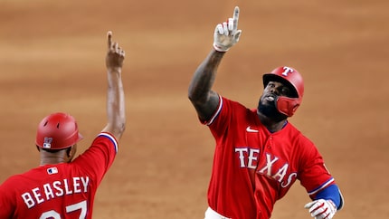 Texas Rangers batter Adolis Garcia (right) celebrates his walk-off 3-run homer in the tenth...