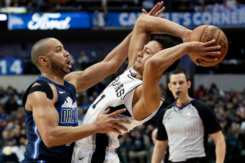 Dallas Mavericks guard Devin Harris (34) defends as San Antonio Spurs' Bryn Forbes (11)...