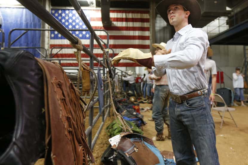 Bull rider McKennon Wimberly prepares his gear at the Mesquite Rodeo on June 6, 2014....