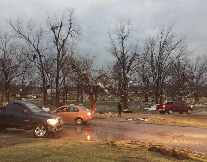 Debris litters the area after a storm swept through the area and damaged homes in Sand...