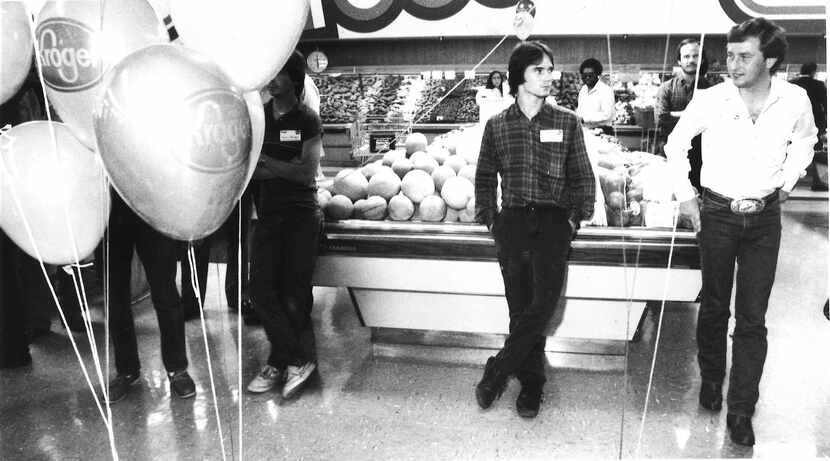 Michael Key (left) scans the produce department with a companion during the mingling period.
