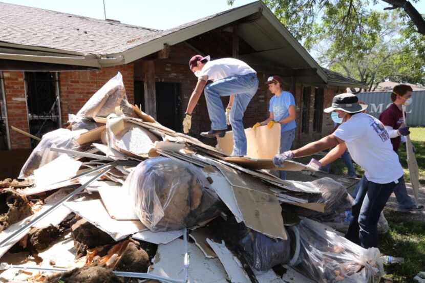 Texas A&M students helped clean up debris at a home in West on Saturday. Residents are...
