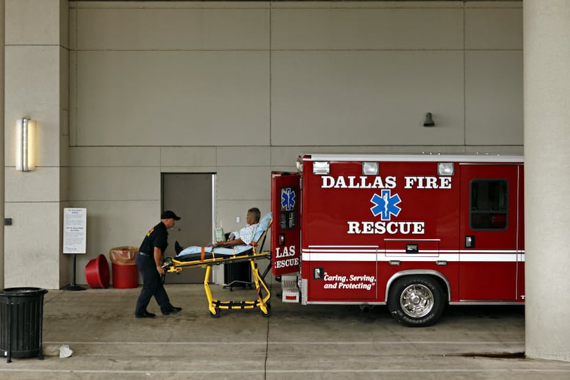 Dallas Fire Rescue ambulance medics deliver a patient to Baylor Medical Center Emergency...