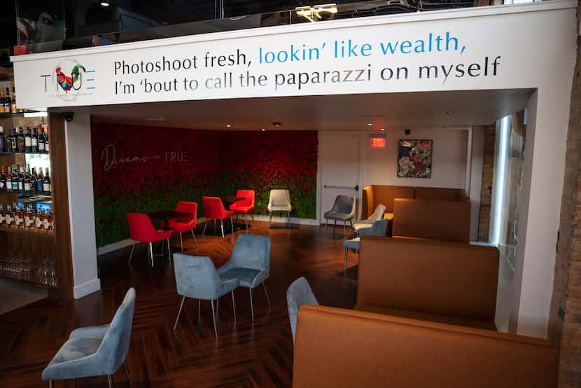 A lyric from Jay-Z and Kanye West's hip-hop track "Otis" hangs over the lounge area at True...