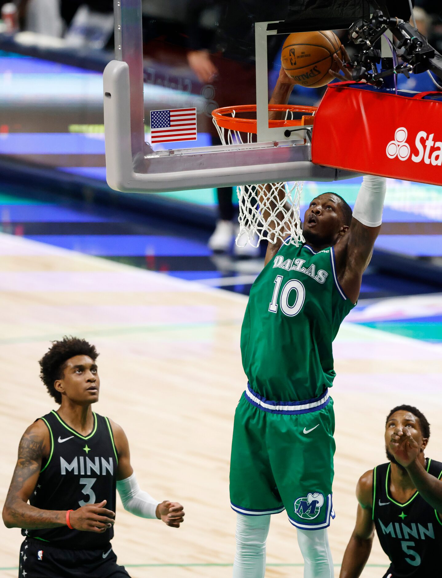 Dallas Mavericks forward Dorian Finney-Smith (10) dunks the ball in front of Minnesota...