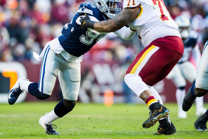 Dallas Cowboys defensive end Demarcus Lawrence (90) tackles Washington Redskins offensive...