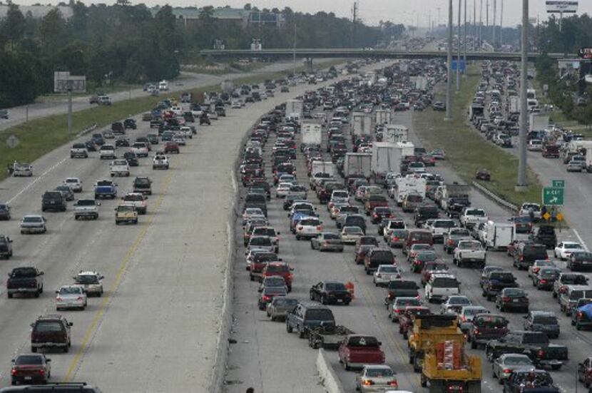 Heavy traffic flows northbound out of Houston on Interstate 45 on both sides of the highway...