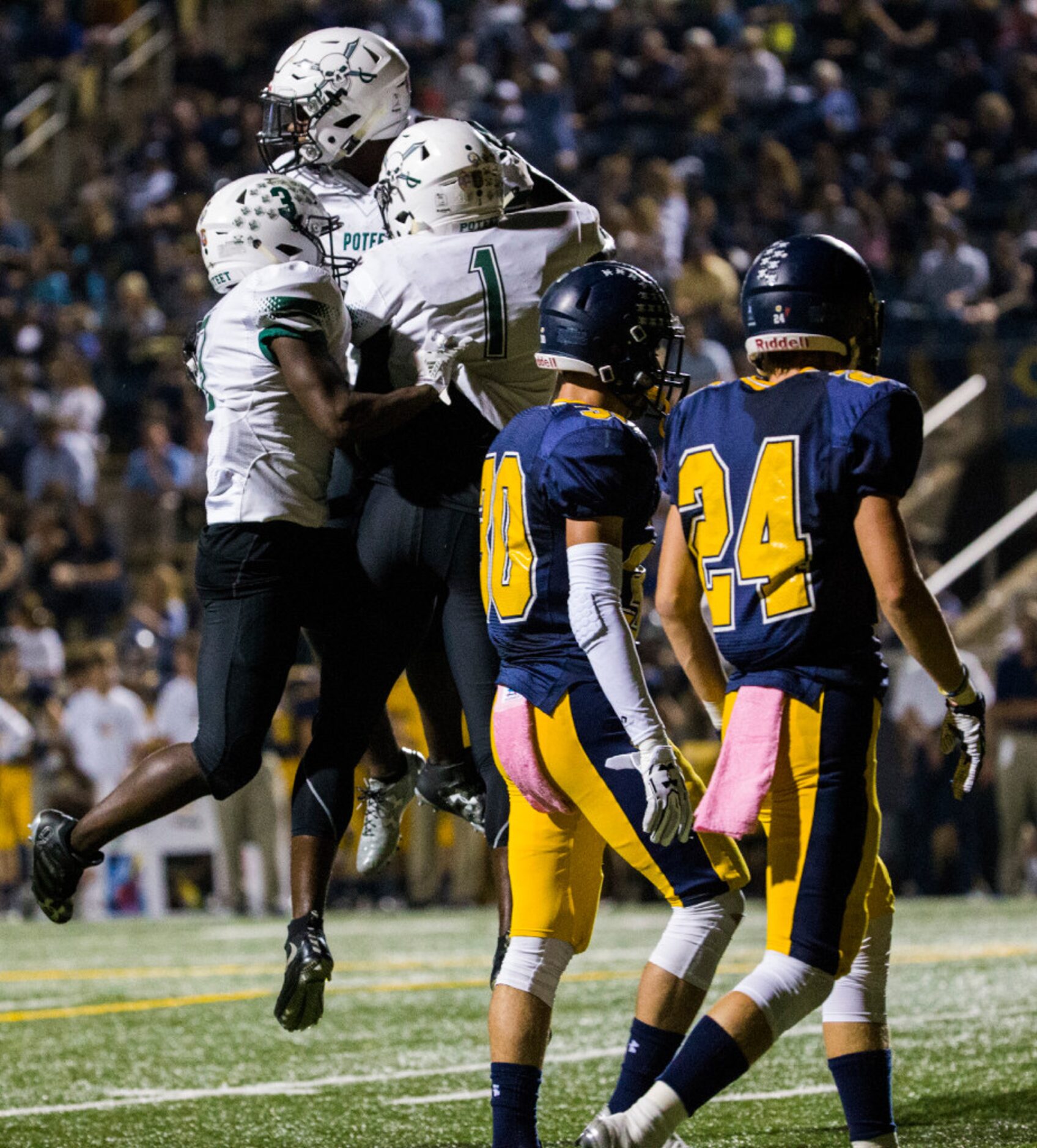 Mesquite Poteet football players celebrate a touchdown as Highland Park football players...