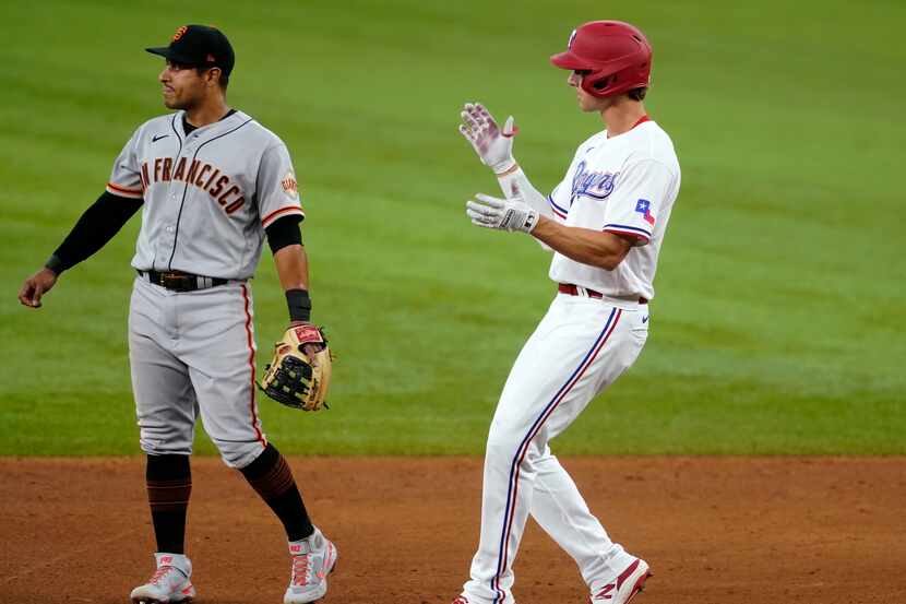 San Francisco Giants second baseman Donovan Solano, left, stands by the bag as Texas...