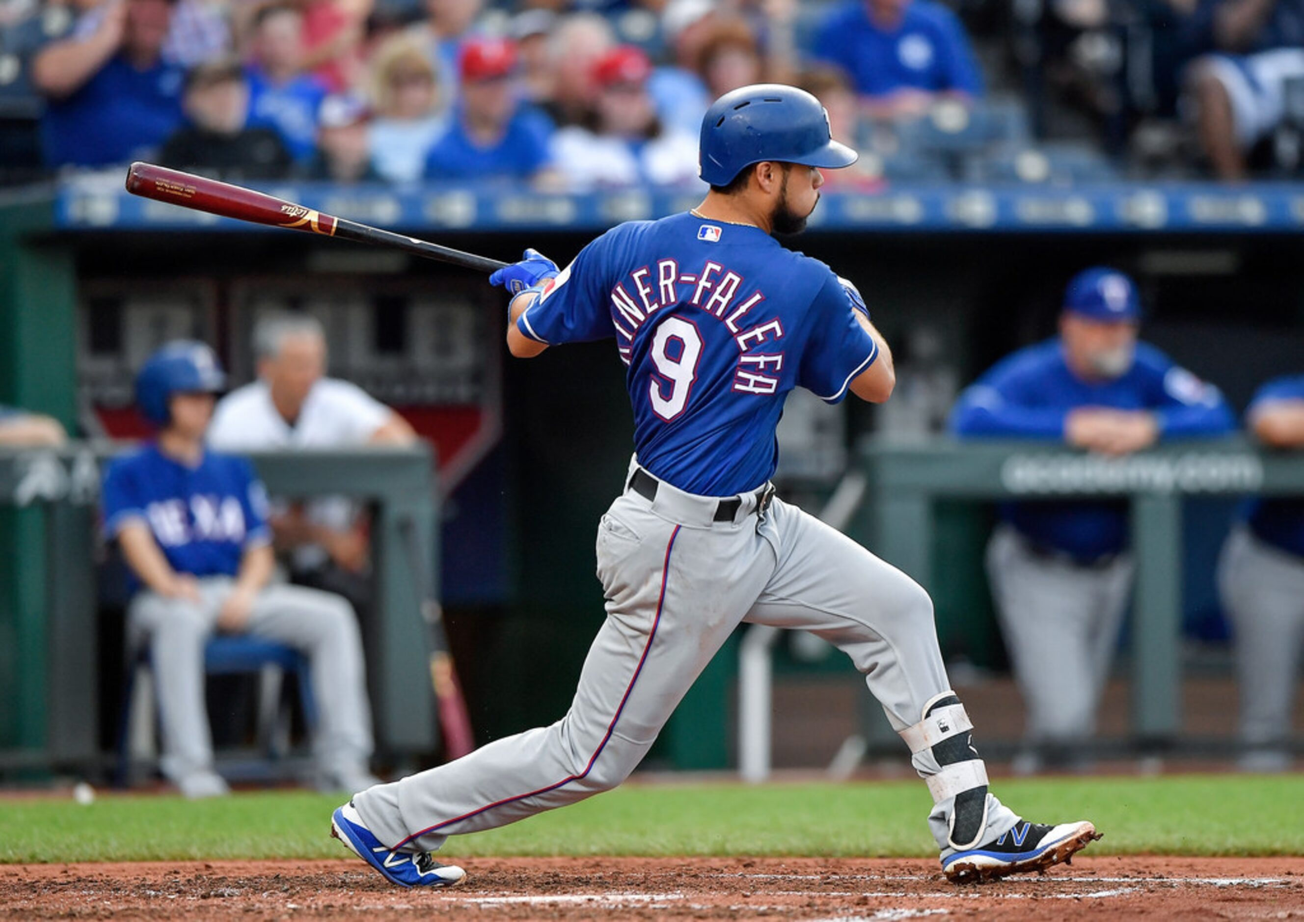 The Texas Rangers' Isiah Kiner-Falefa follows through on an RBI double to score Adrian...