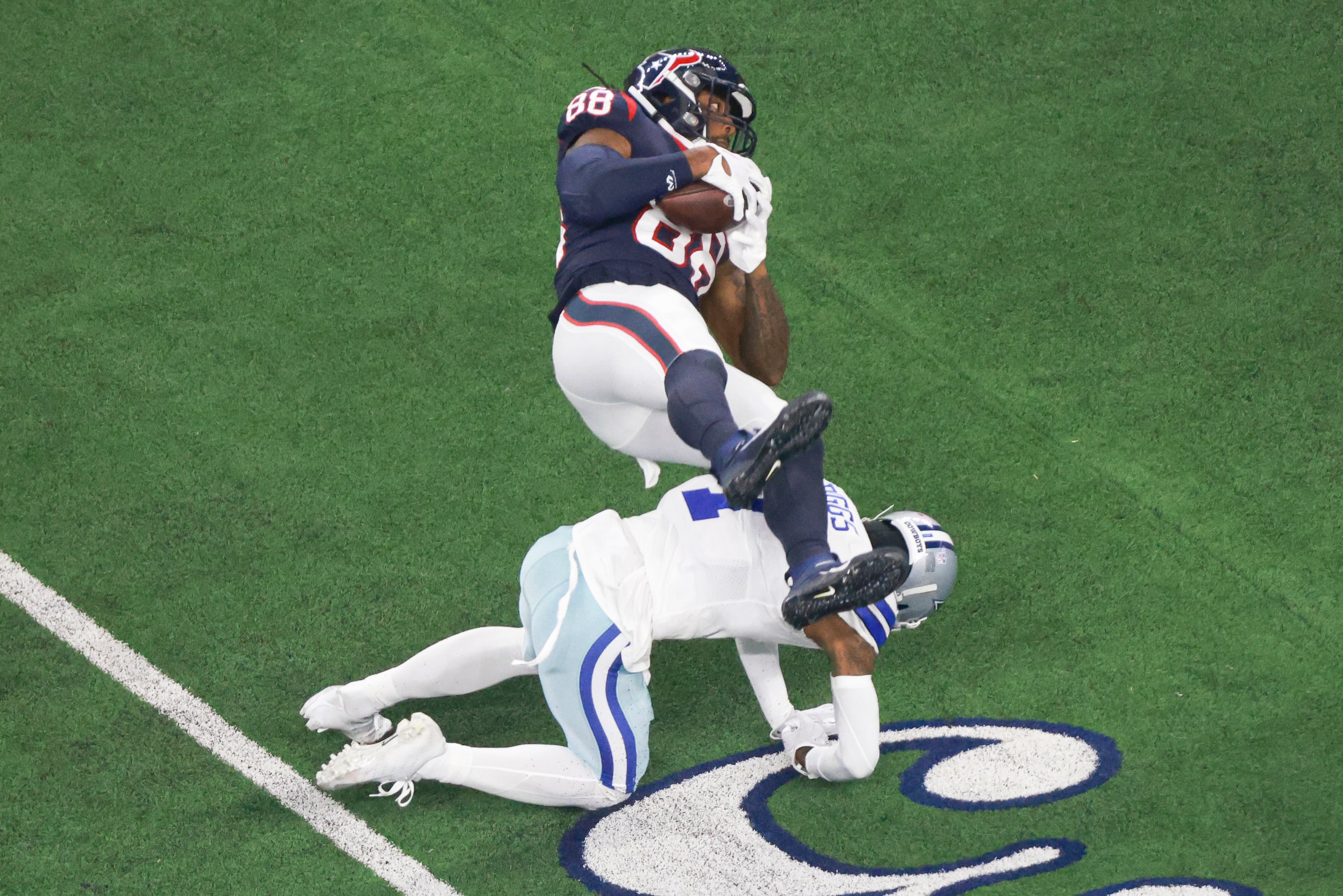 Dallas Cowboys cornerback Trevon Diggs (7) stops Houston Texans tight end Jordan Akins (88)...