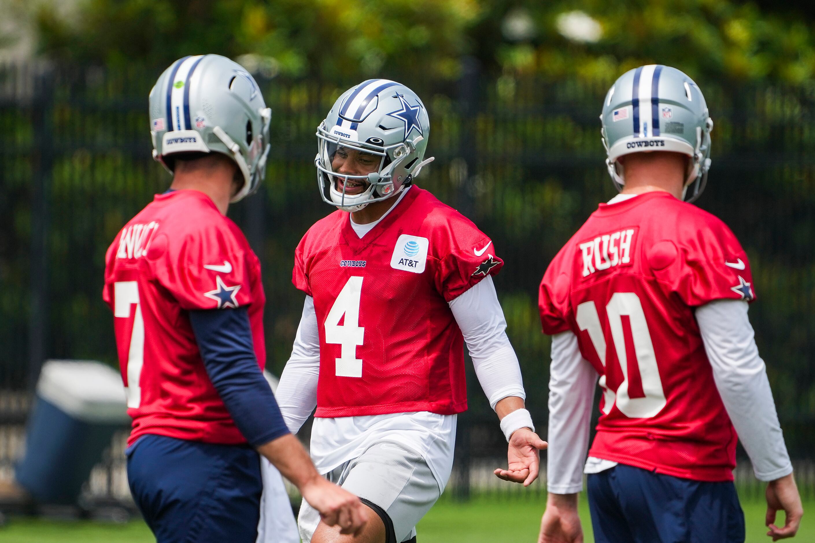 Dallas Cowboys quarterback Dak Prescott (4) laughs with fellow quarterbacks Ben DiNucci (7)...