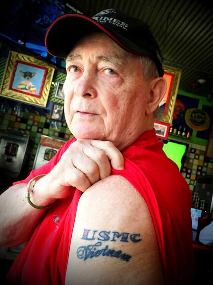 Mike Timmerman, 72, a Vietnam veteran, shows one of his tattoos during lunch at Chuy's on...