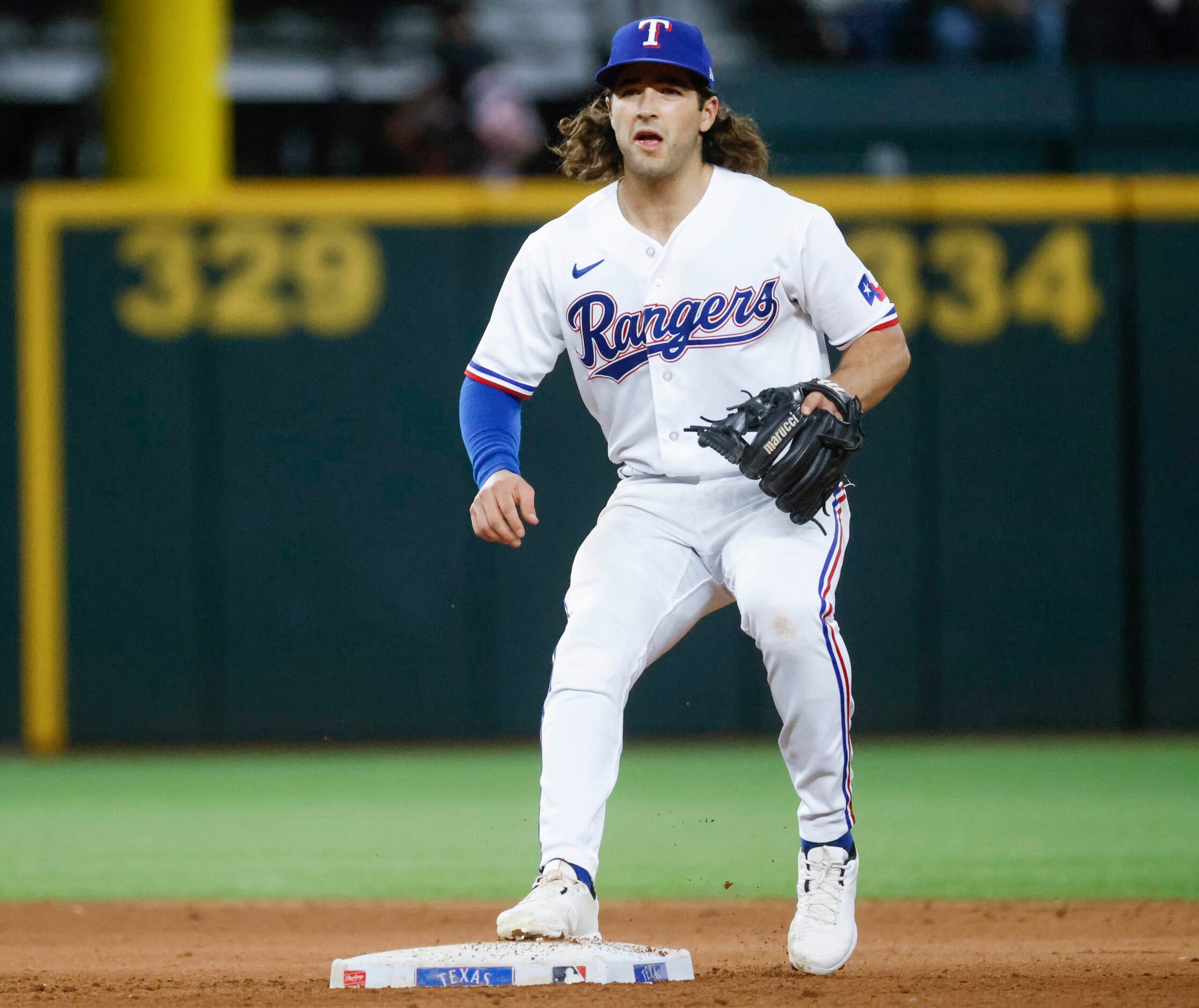 Texas Rangers shortstop Josh Smith fields during the seventh inning of a baseball game...