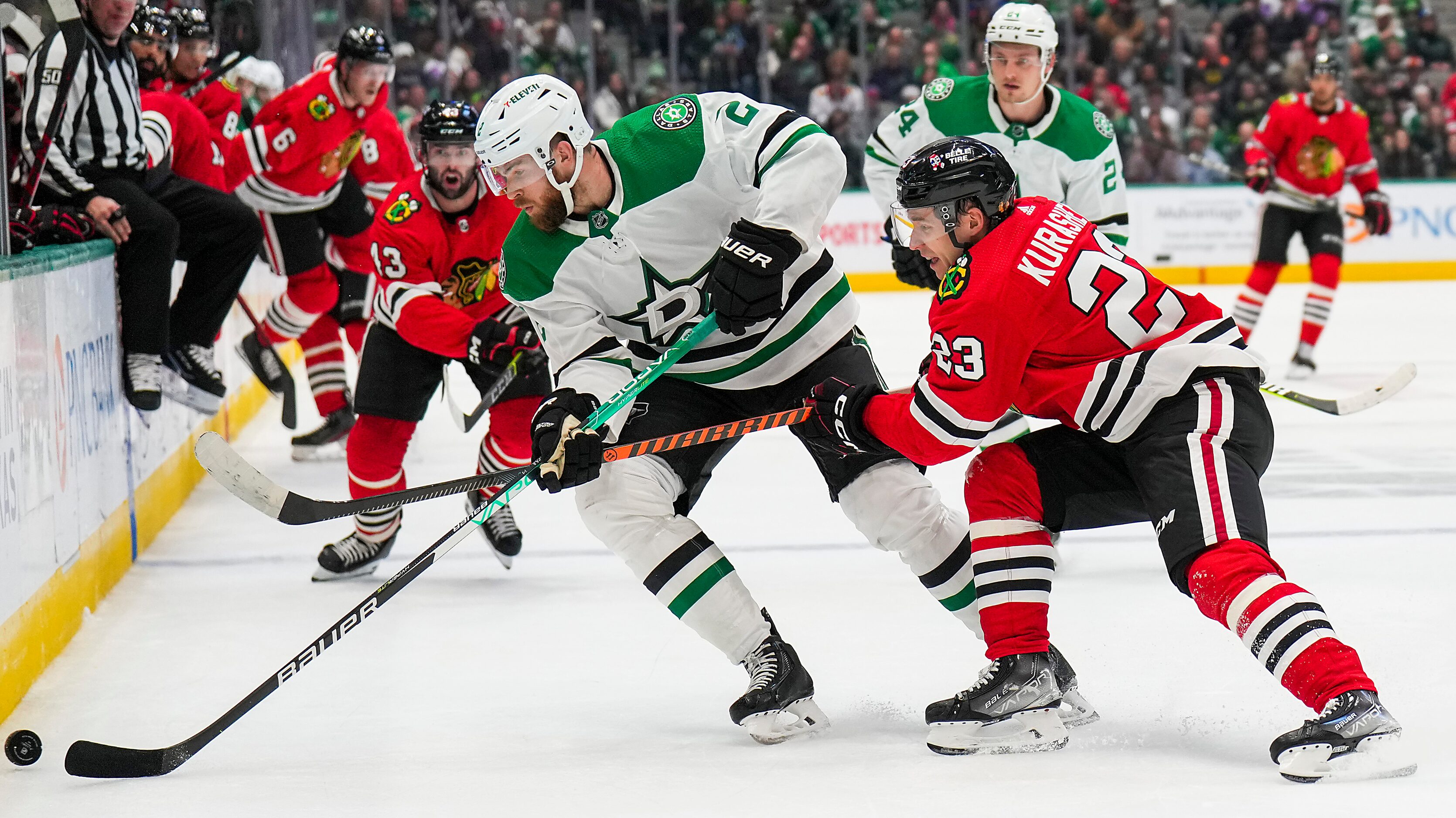 Dallas Stars defenseman Jani Hakanpaa (2) fights for the puck against Chicago Blackhawks...