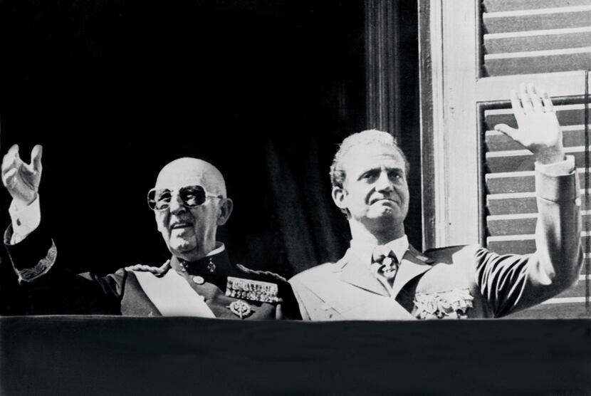 General Francisco Franco  and then-Prince Juan Carlos saluting the crowd in Madrid in...