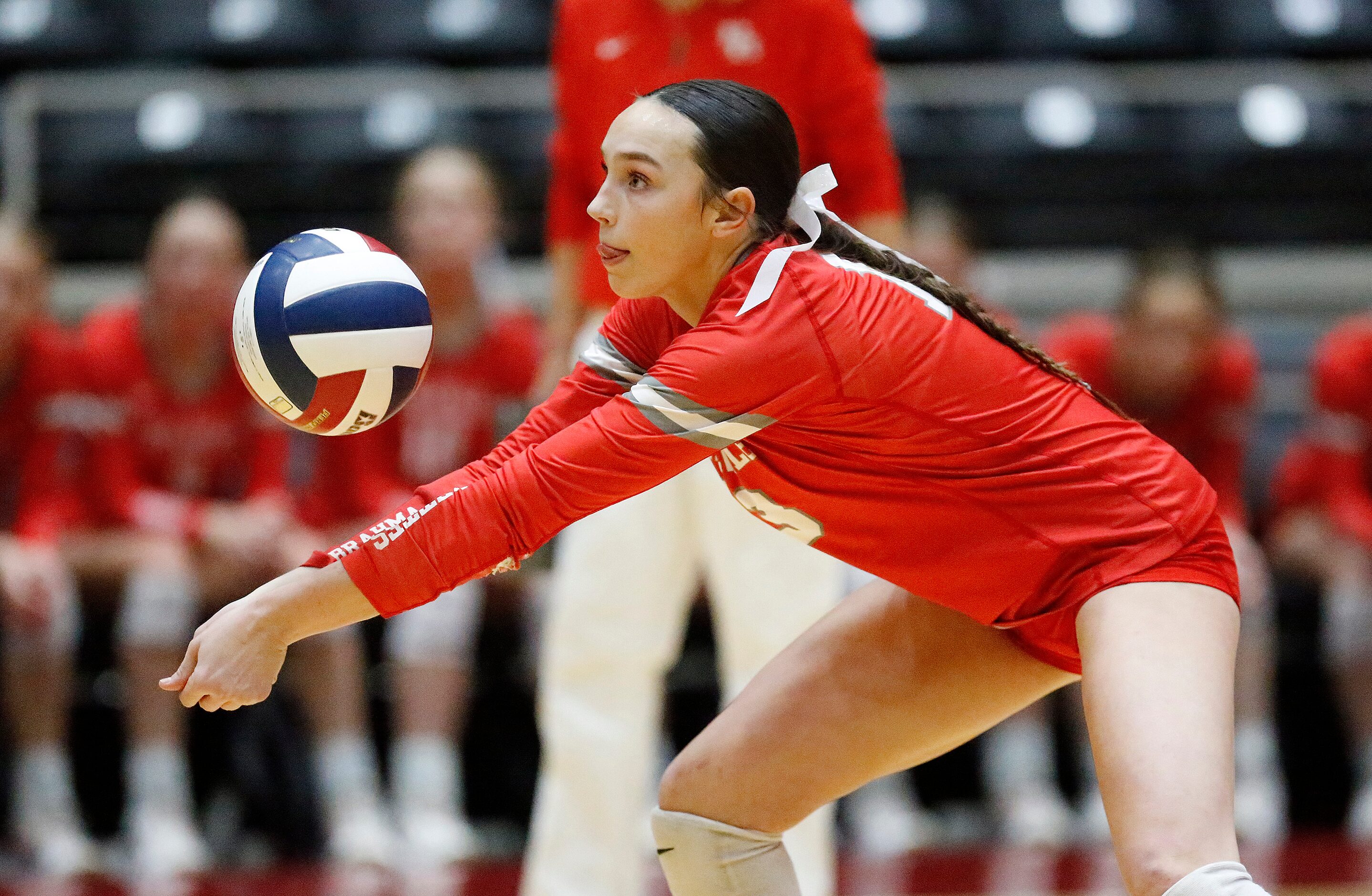 Bellville High School’s Sydney McKay (13) receives a serve during game one as Aubrey High...