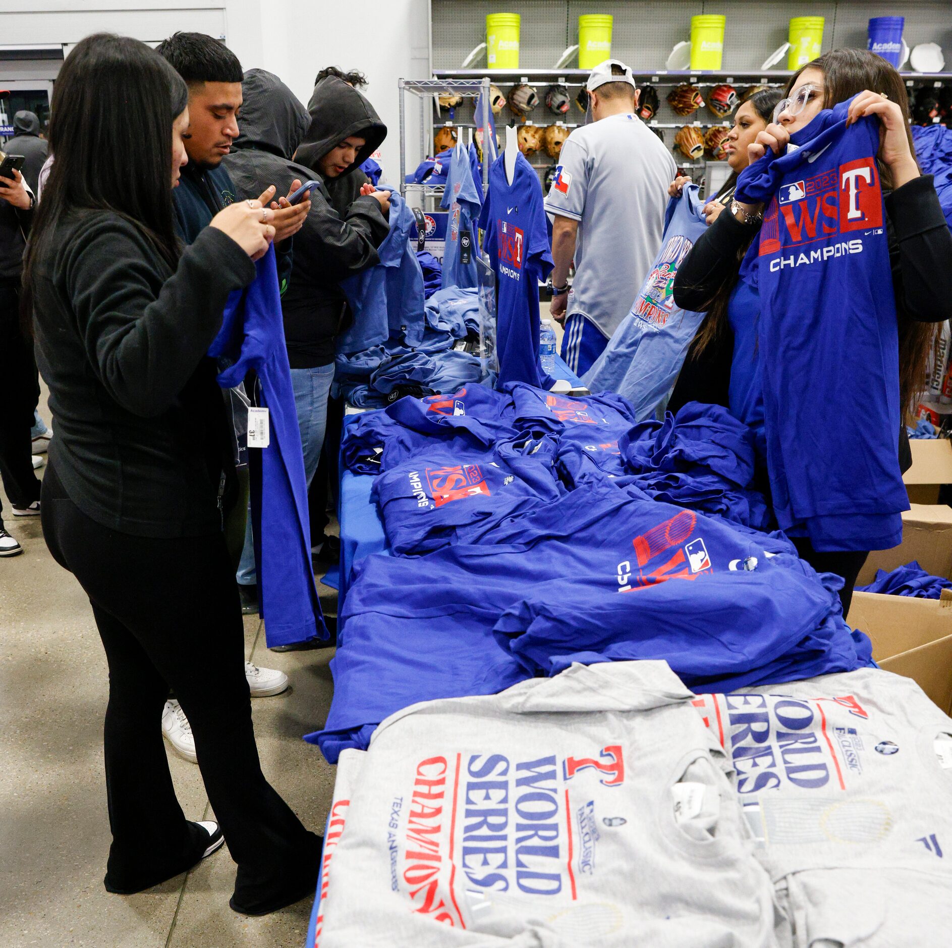 People shop for Texas Rangers World Series championship merchandise at an Academy Sports,...