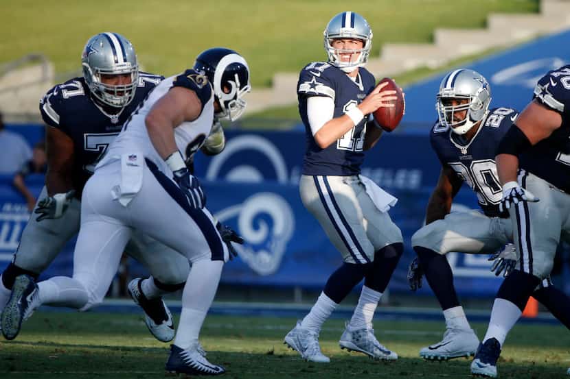 Dallas Cowboys quarterback Kellen Moore (17) looks for an open receiver during the first...