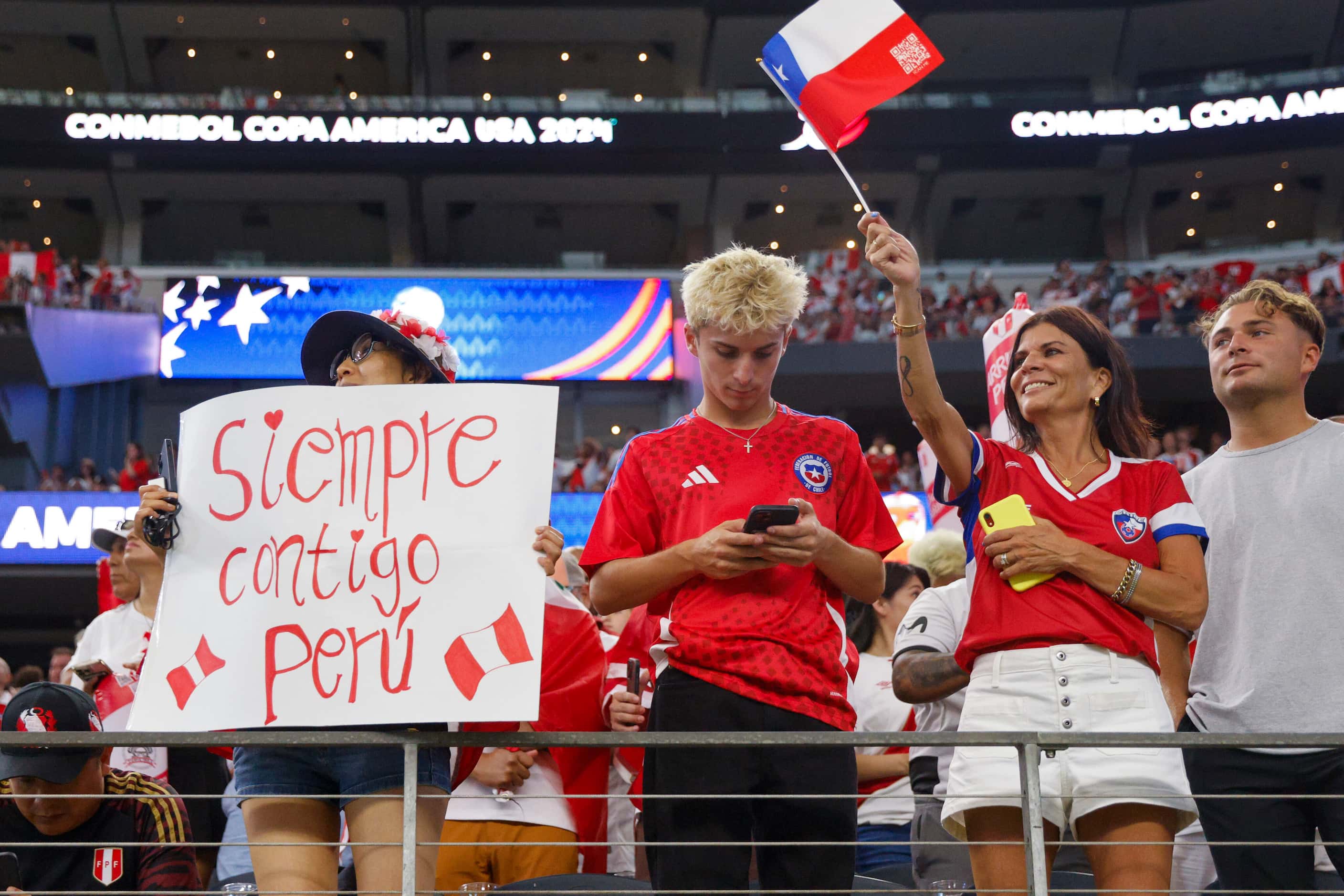 Soccer fans stand and cheer before a Copa America Group A soccer match between Chile and...