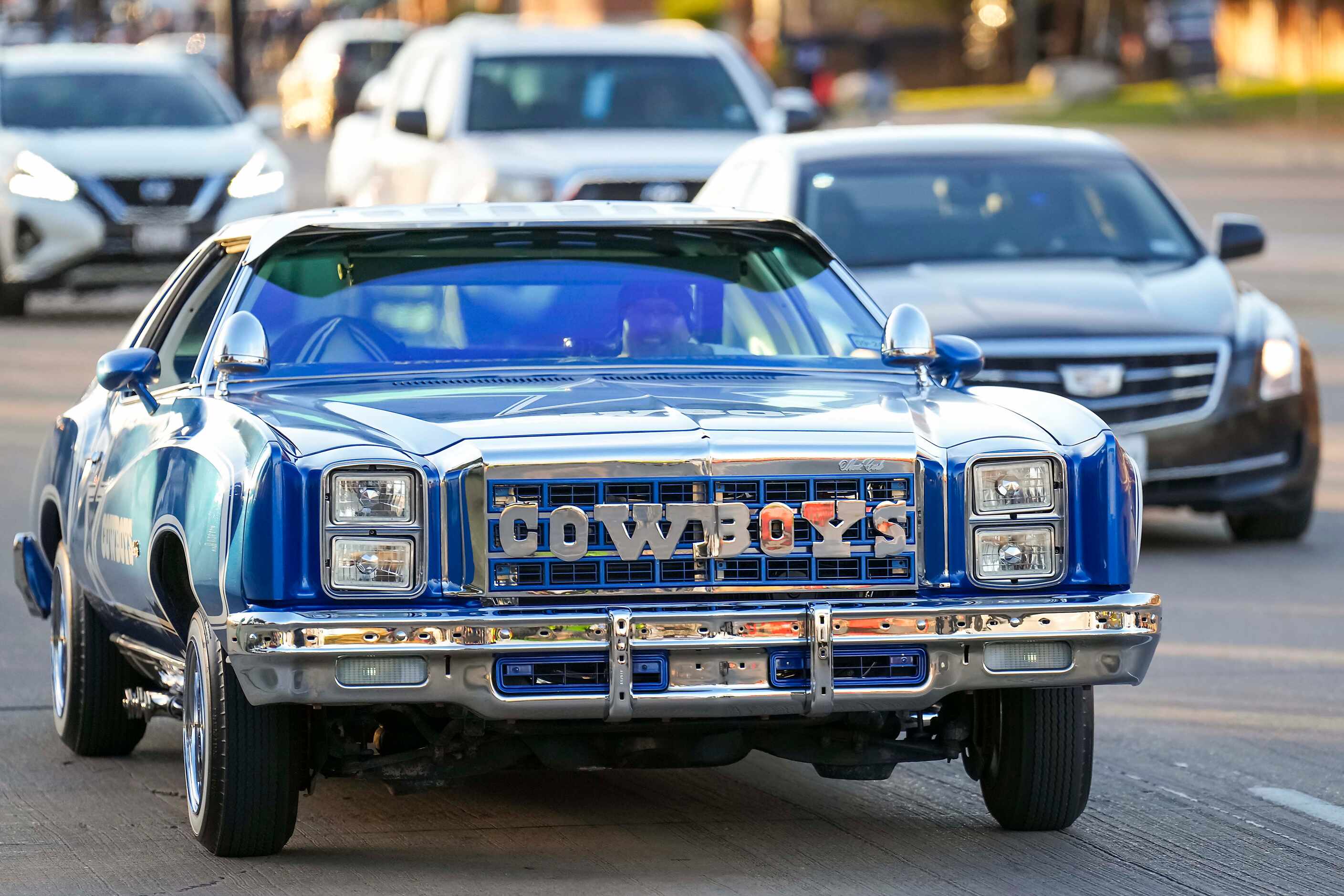 A lowrider passes the stadium before an NFL football game between the Dallas Cowboys and the...