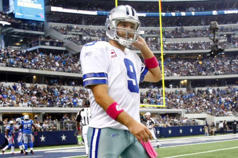 Tony Romo walks back to the sideline after throwing an interception that Detroit cornerback...