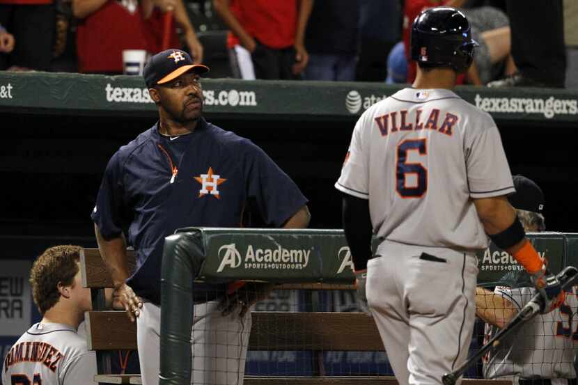 Houston Astros manager, Bo Porter, looks on as shortstop Jonathan Villar (6) walks back to...