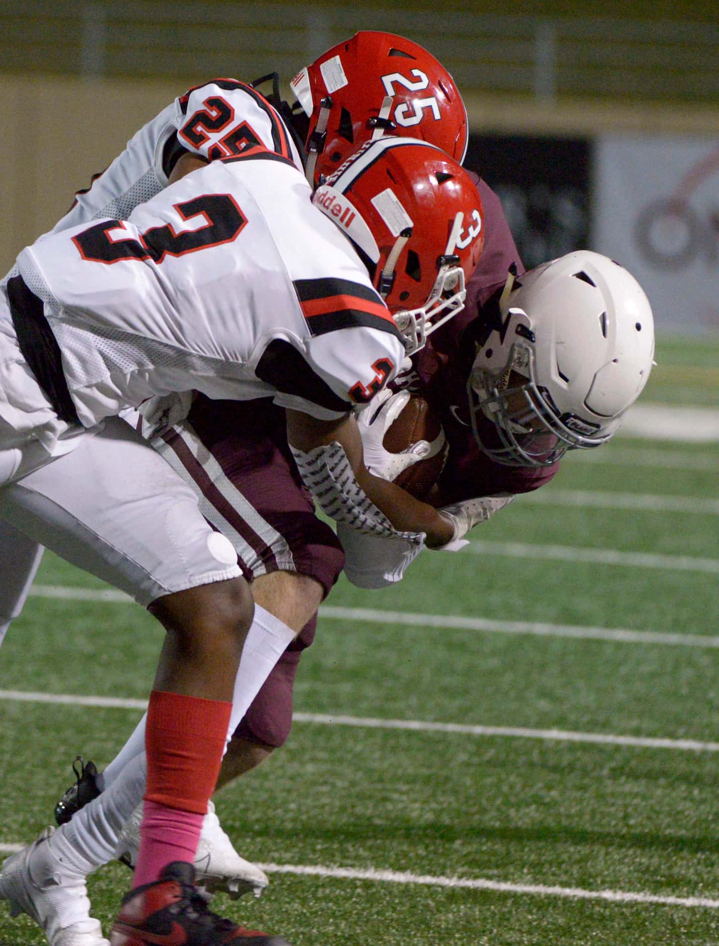 Plano’s Michael Dorsey is tackled by Lake Highlands Jeremiah Richards (3) and Adrian Mateos...