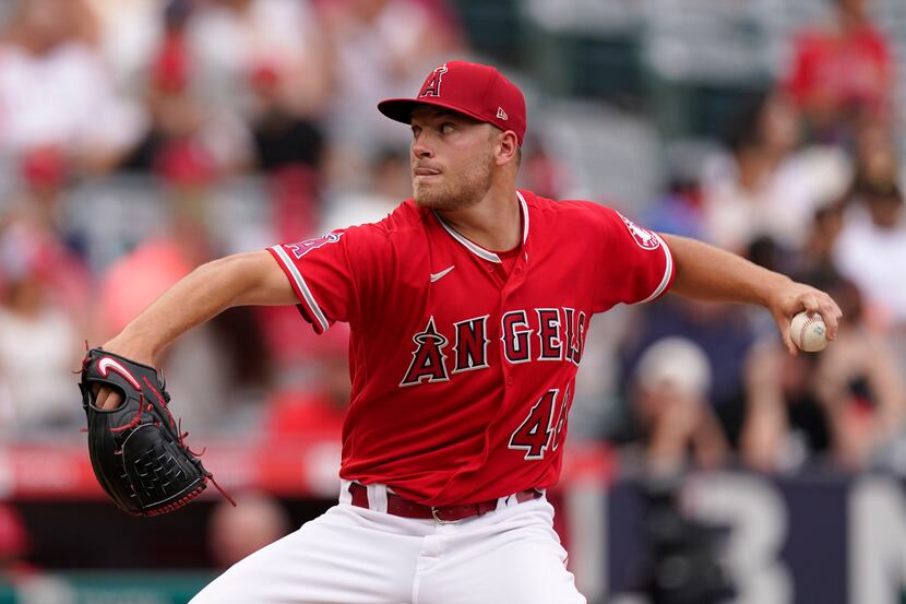 Los Angeles Angels starting pitcher Reid Detmers throws to the plate during the second...