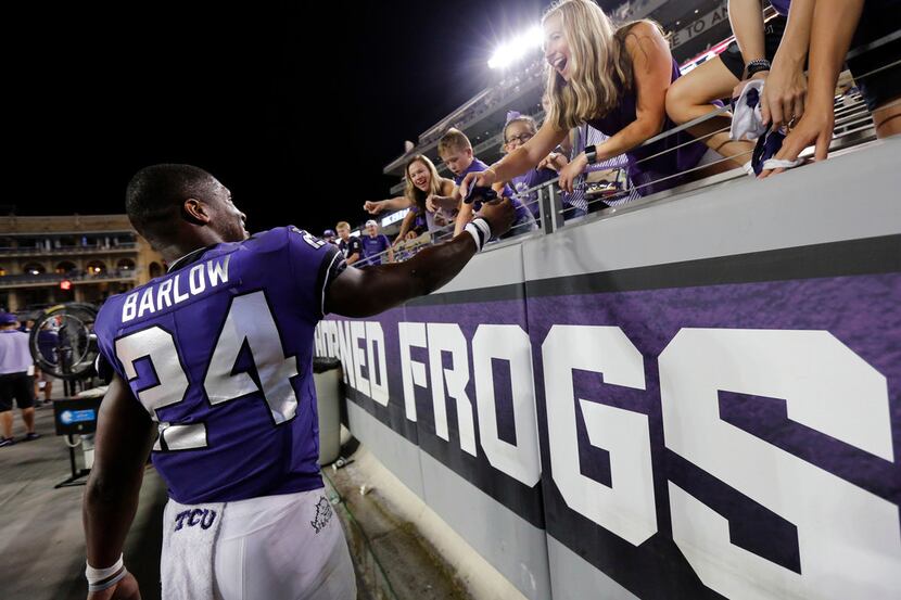 TCU Horned Frogs running back Darwin Barlow (24) gives away his gloves to a fan as they...