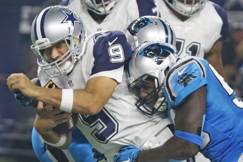 Dallas Cowboys quarterback Tony Romo (9) grimaces as he is hurt on this third quarter sack...