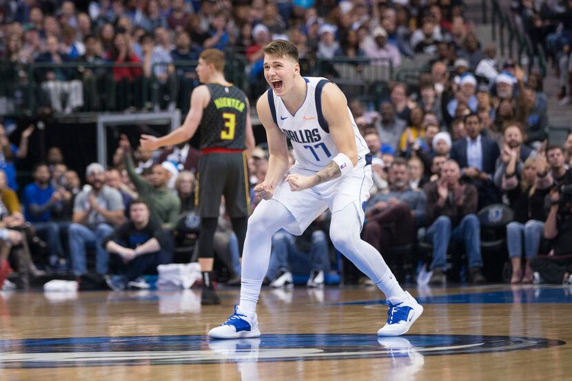 Dallas Mavericks forward Luka Doncic (77) celebrates after a score during the second half of...
