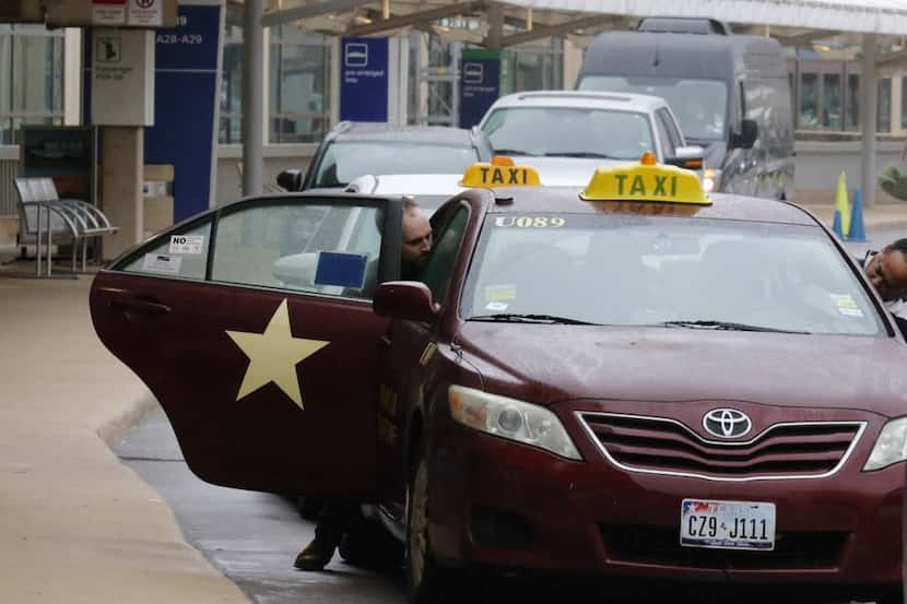A passenger gets into a taxi at Terminal A at DFW International Airport. (David Woo/Staff...