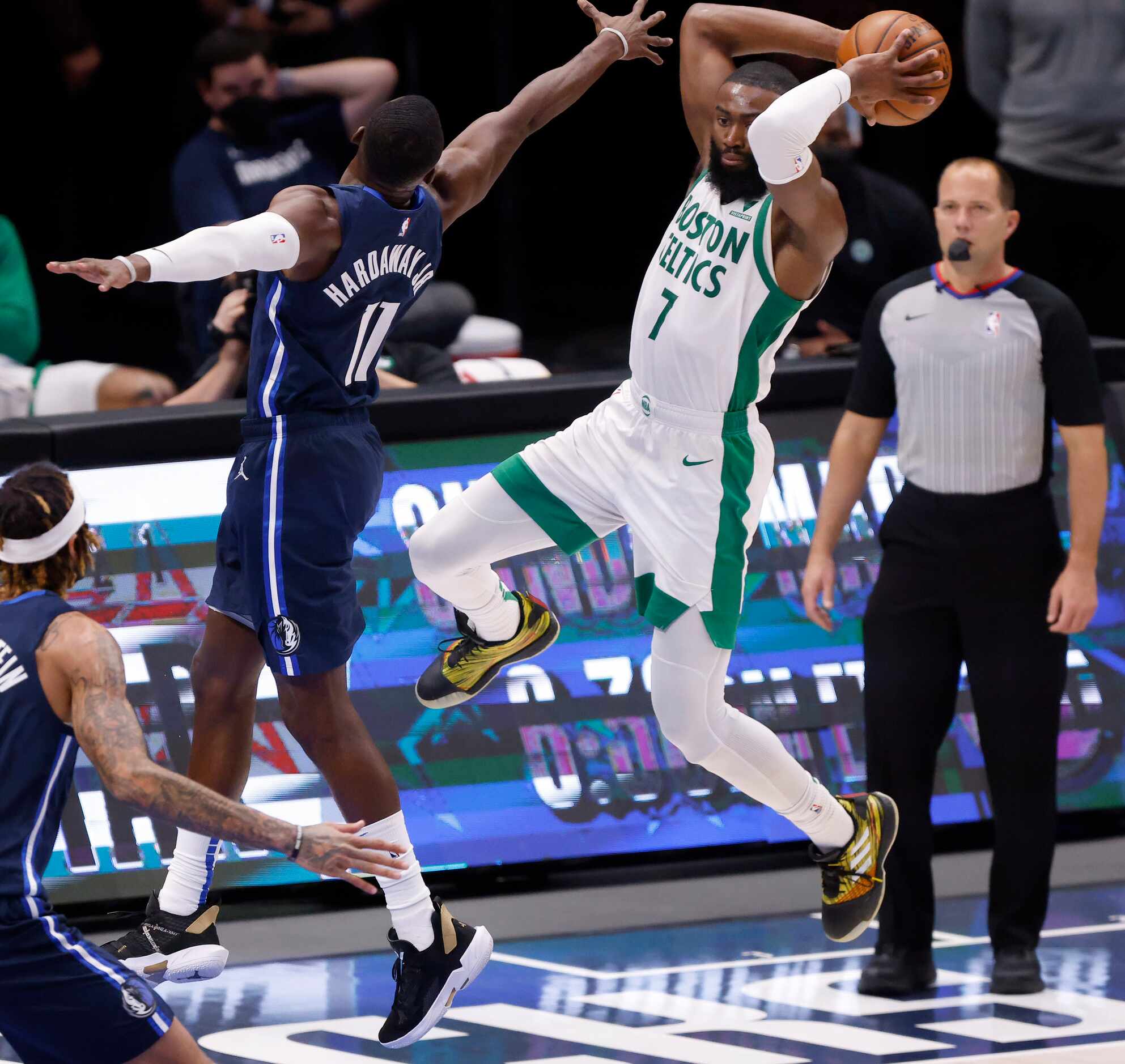 Boston Celtics guard Jaylen Brown (7) looks to pass as he's guarded by Dallas Mavericks...