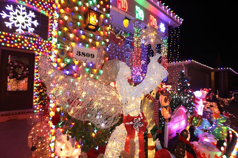 Near the "gumdrop walls," an angel stands over the Burkmans' memory garden display, which...