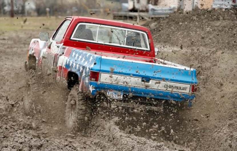 
Calvin Corbett of Windom drives his Chevy Truck, "Brutus," through the mud at the Nevada...