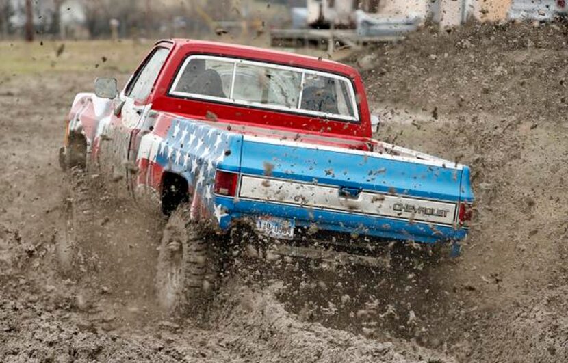 
Calvin Corbett of Windom drives his Chevy Truck, "Brutus," through the mud at the Nevada...