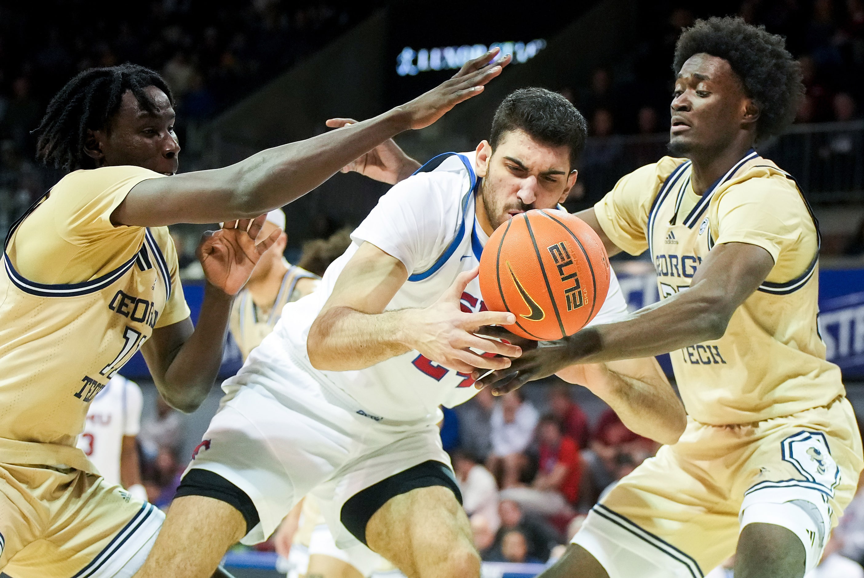 SMU center Samet Yigitoglu fights for the ball against Georgia Tech forward Baye Ndongo...