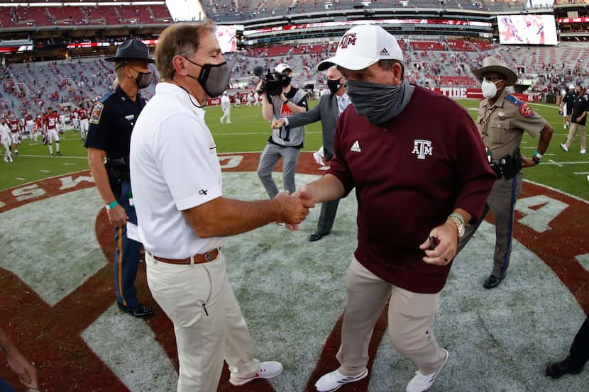 Nick Saban of the Alabama Crimson Tide shakes hands with Jimbo Fisher of the Texas A&M...