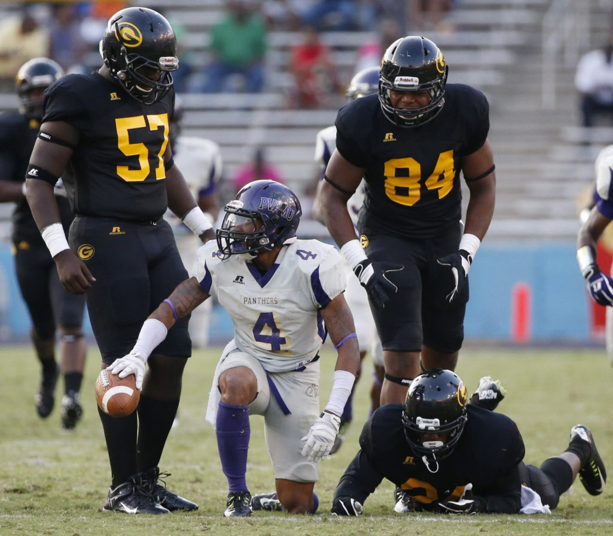 Grambling State long snapper Byron Williams (57), tight end Chris Brazil (84) and running...