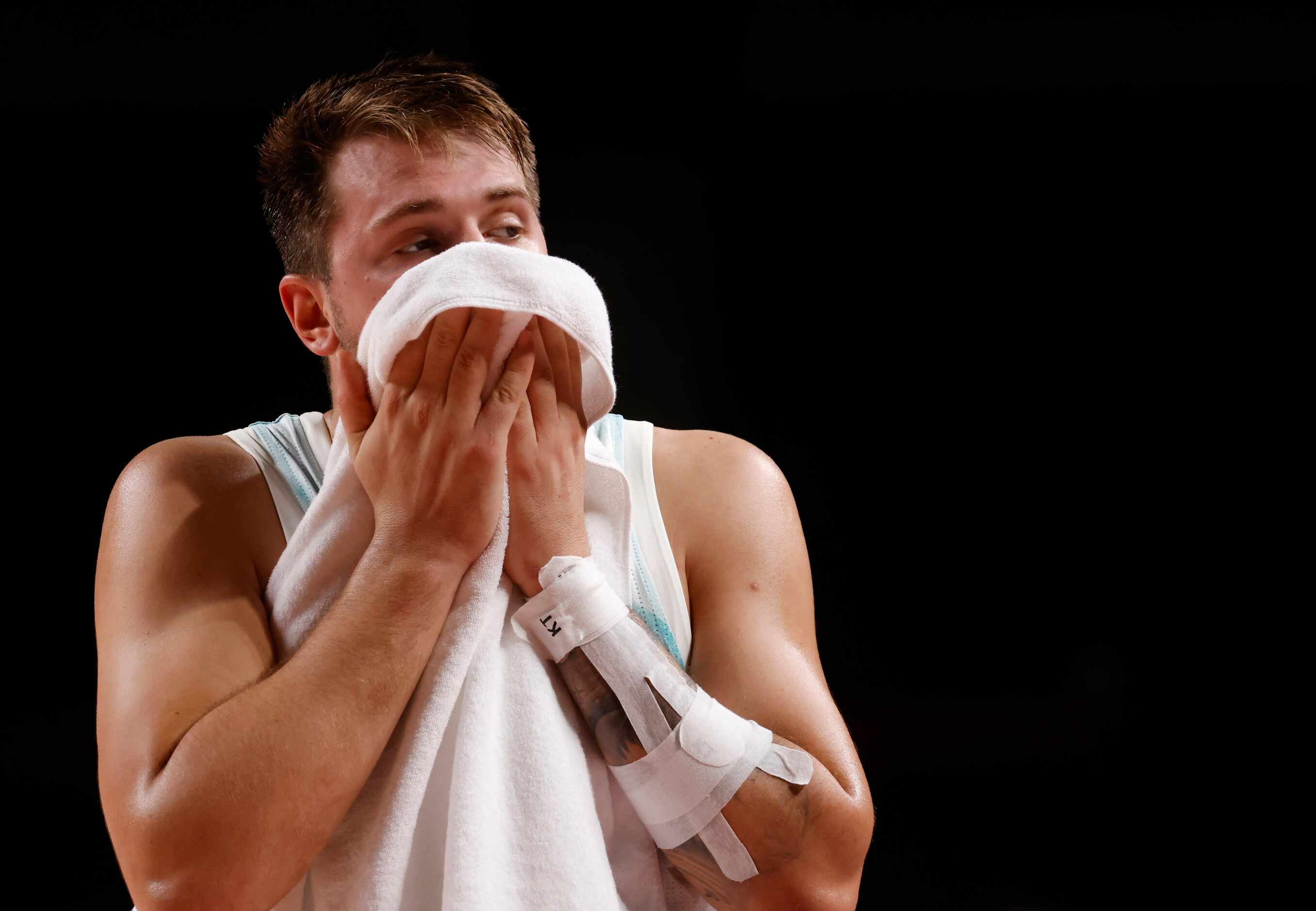 Slovenia’s Luka Doncic (77) wipes his face in a game against Australia during the third...