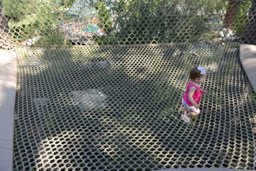 Ella Hufsey plays in the netting surrounding a hollowed tree at the Rory Meyers Children's...