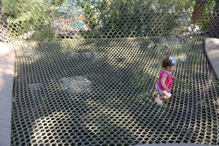 Ella Hufsey plays in the netting surrounding a hollowed tree at the Rory Meyers Children's...