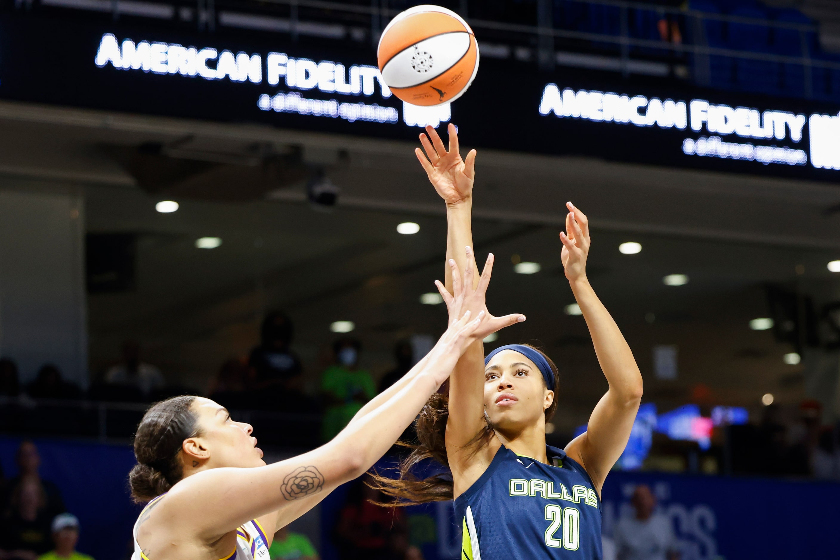 Dallas Wings forward Isabelle Harrison (20) shoots past Los Angeles Sparks center Liz...