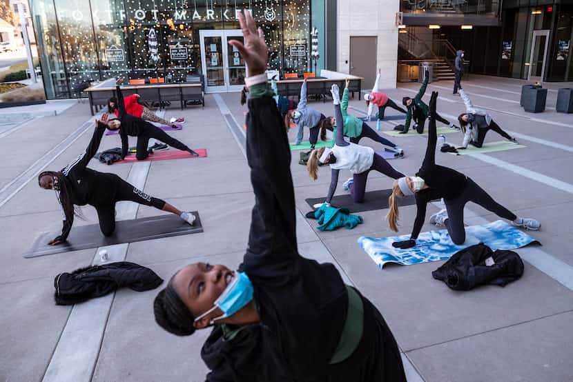Pilates instructor Jasmine White, center, conducts a fitness class outside of Crisp & Green...