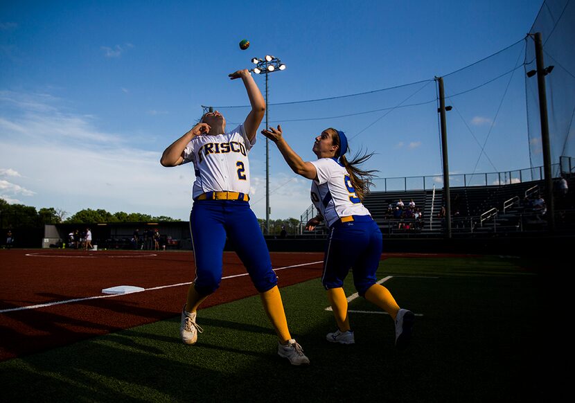  Frisco's Stephanie Clark (2) and MJ Johnson (9) reach to hit a hacky sack as they play with...